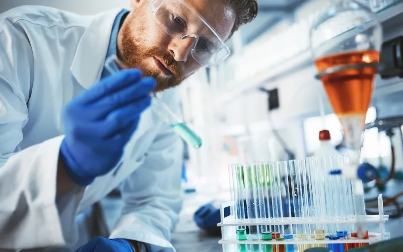 Male student of chemistry working in laboratory