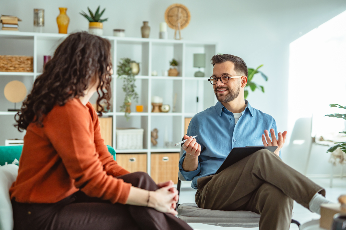 Young,Woman,Receiving,Support,And,Advice,From,A,Male,Psychologist,