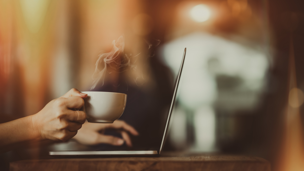 Laptop,And,Coffee,Cup,In,Girl's,Hands