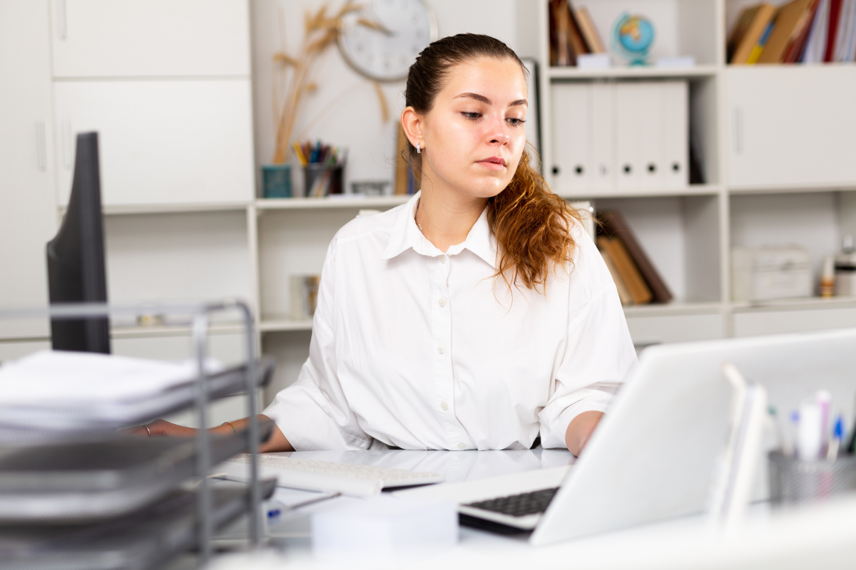 Focused,Young,Woman,Secretary,Working,Alone,At,Her,Workplace,On
