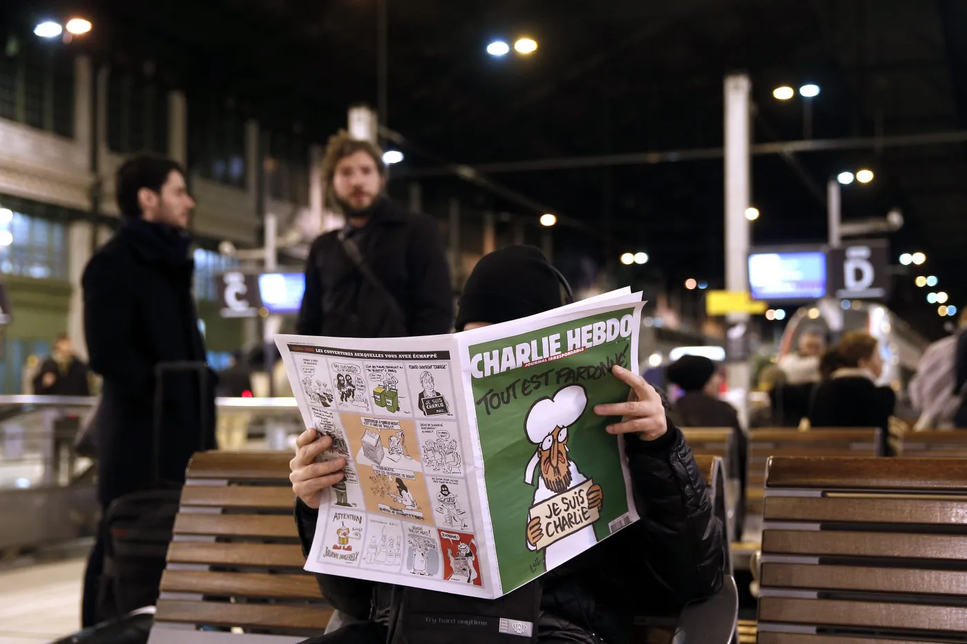 Mężczyzna czyta "Charlie Hebdo"