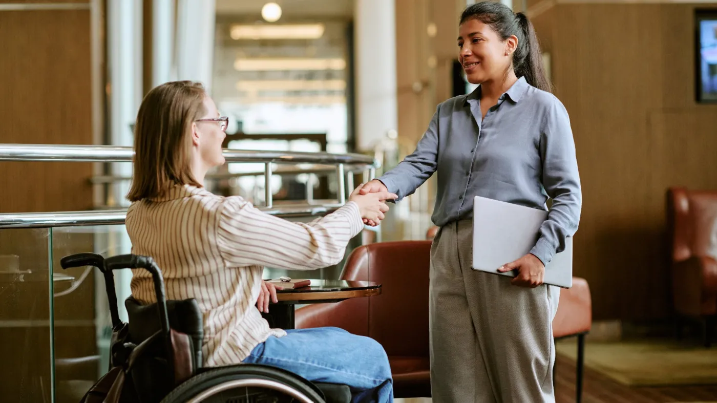 Caucasian,Young,Adult,Woman,With,Disability,In,Wheelchair,Shaking,Hands