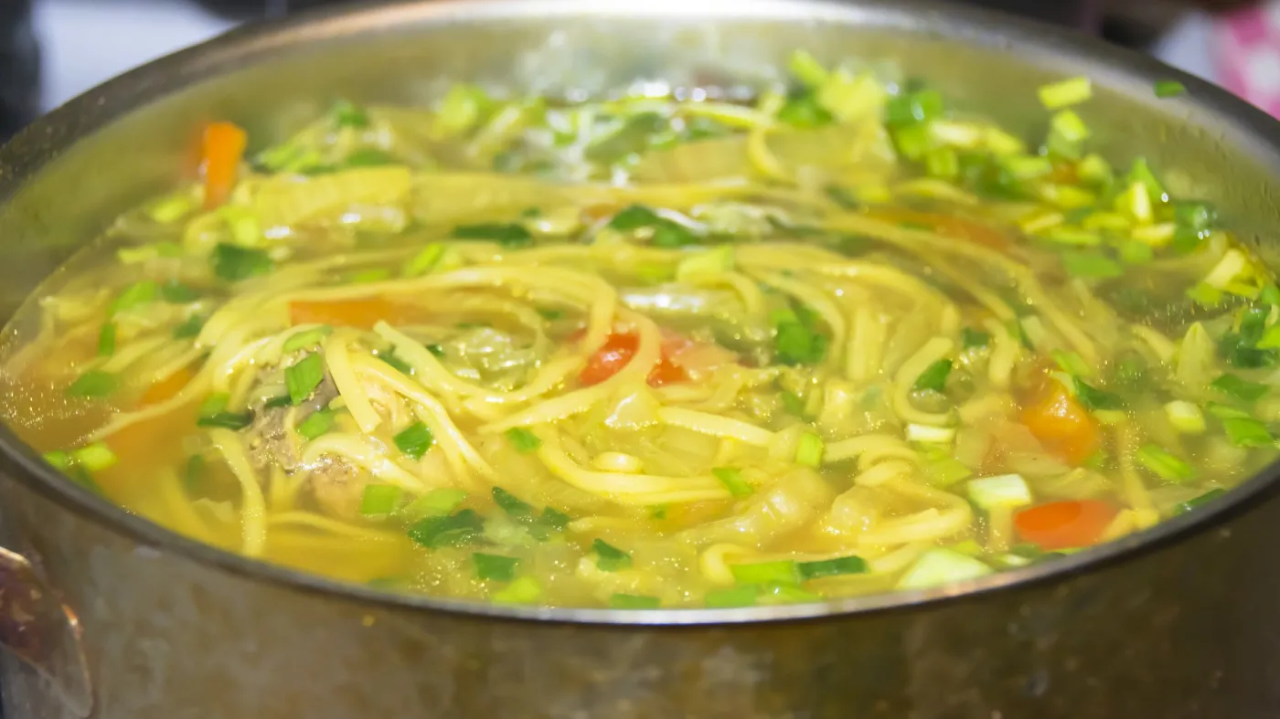 Bowler,Of,Yellow,Chicken,Soup,With,Noodles,And,Green,Onions