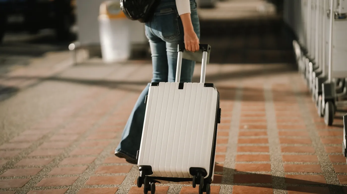 Close-up,Of,A,Young,Asian,Woman,Holding,A,Passport,While