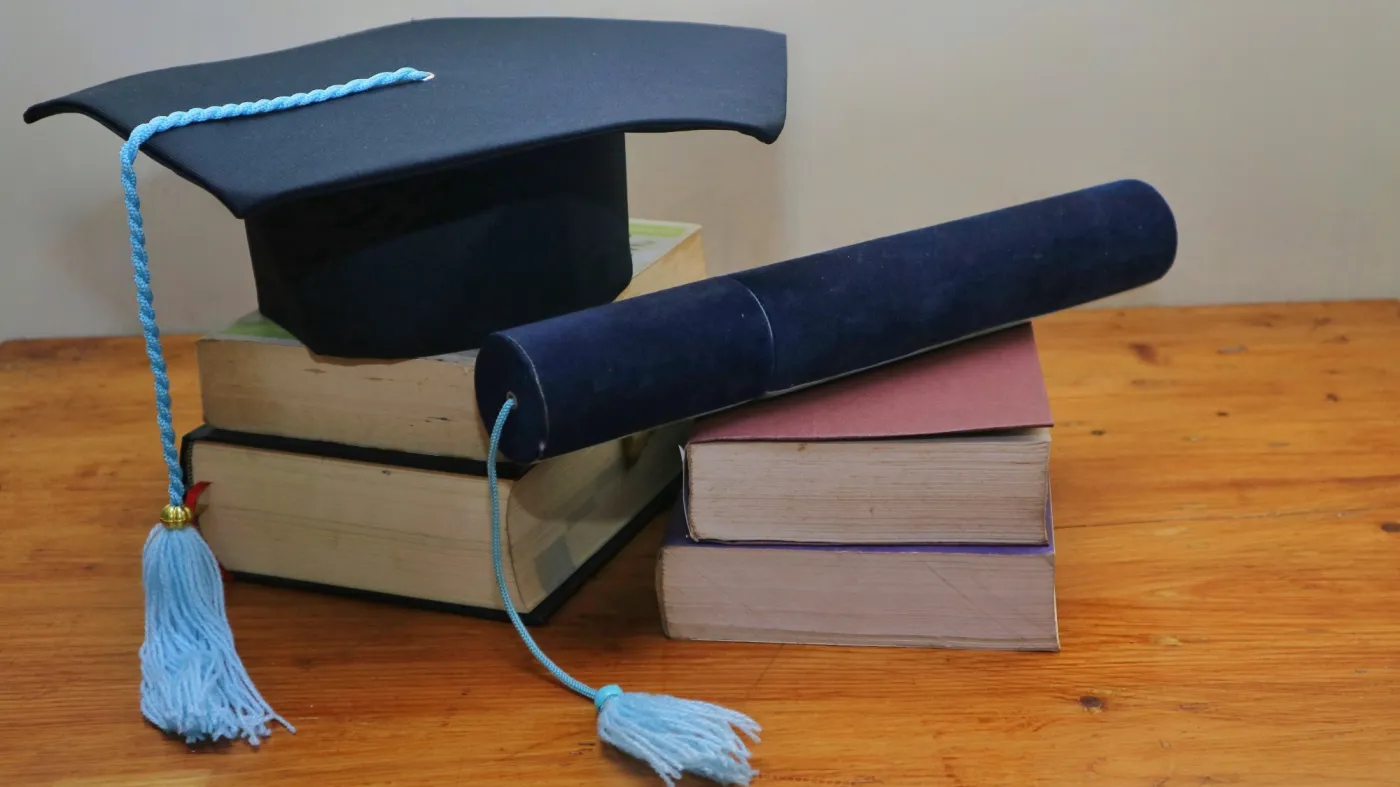 Books,,Graduation,Caps,And,Diplomas.,With,Creative,Layout,,Located,On