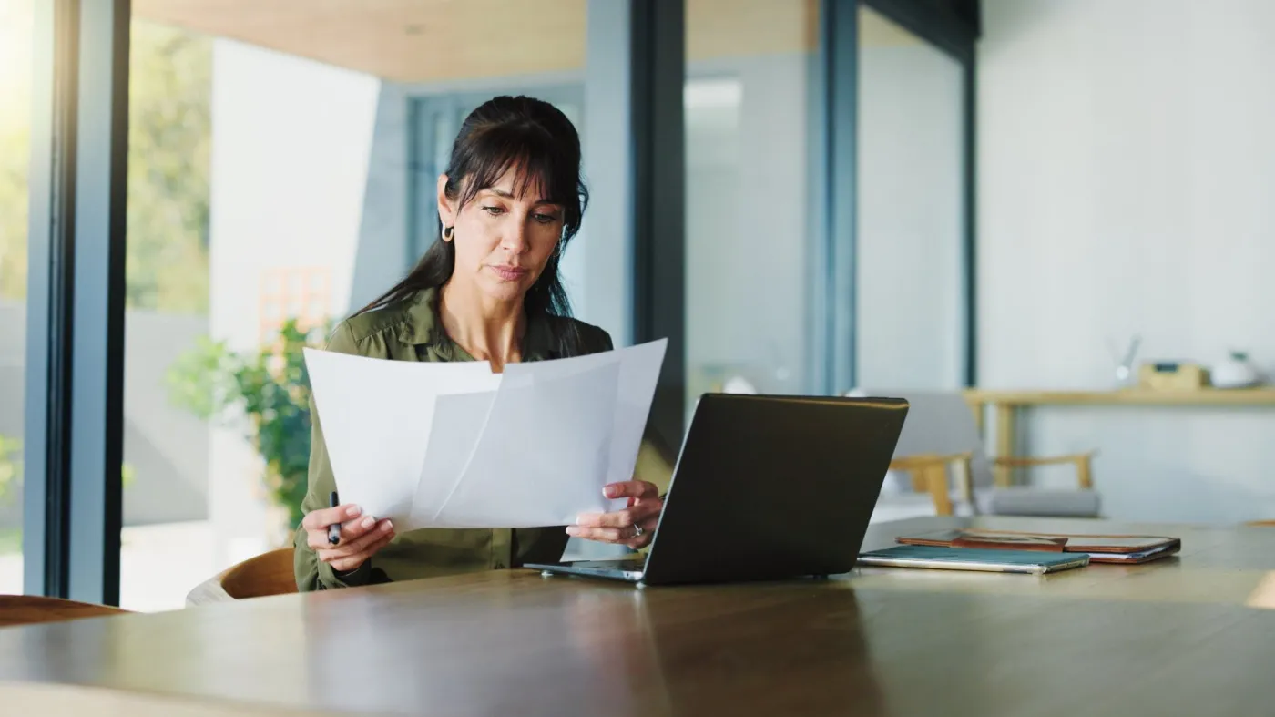 Business,,Woman,And,Document,With,Laptop,At,House,For,Real