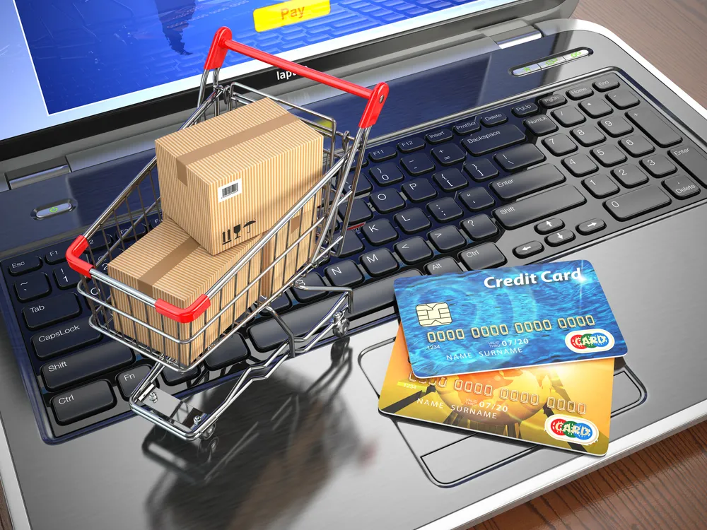E-commerce.,Shopping,Cart,And,Credit,Cards,On,Laptop.,3d
