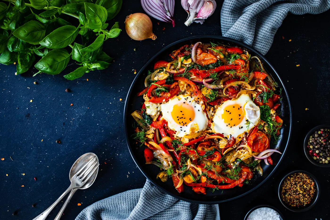Shakshuka,-,Fried,Eggs,With,Vegetables,On,Black,Wooden,Table