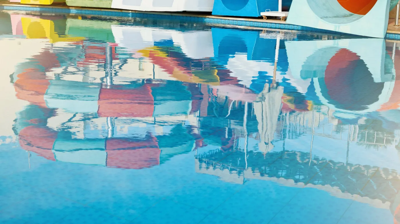 Reflection,Of,Water,Park,With,Water,Colored,Flights,In,Pool,