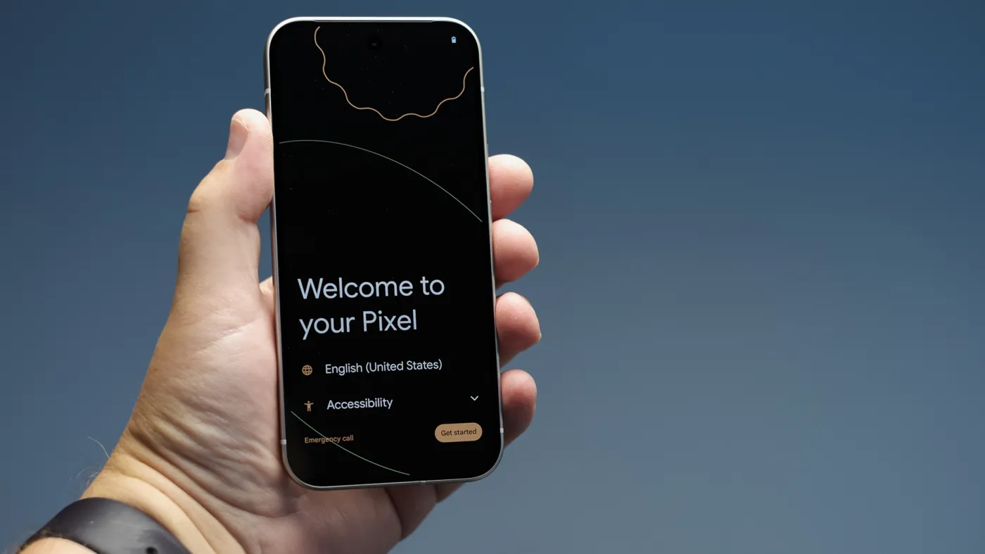 Dłoń trzymająca smartfon Google Pixel. Na smartfonie jest wyświetlony ekran powitalny.