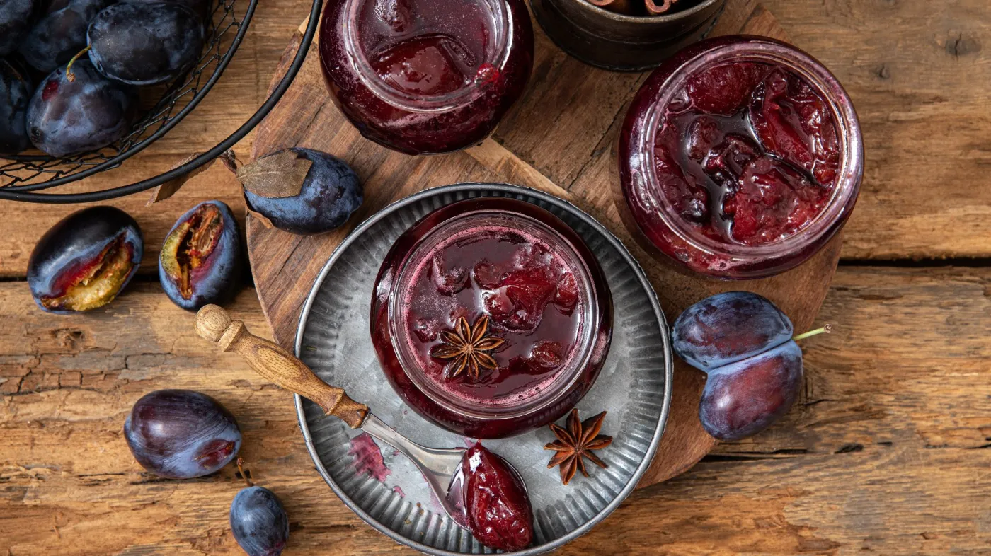 Homemade,Plum,Jam,In,A,Glass,Jar,On,A,Wooden