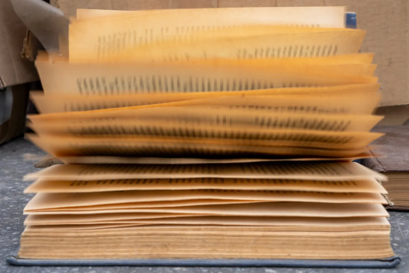 Open,Vintage,Book,With,Fan,Of,Turning,Yellowed,Pages,With