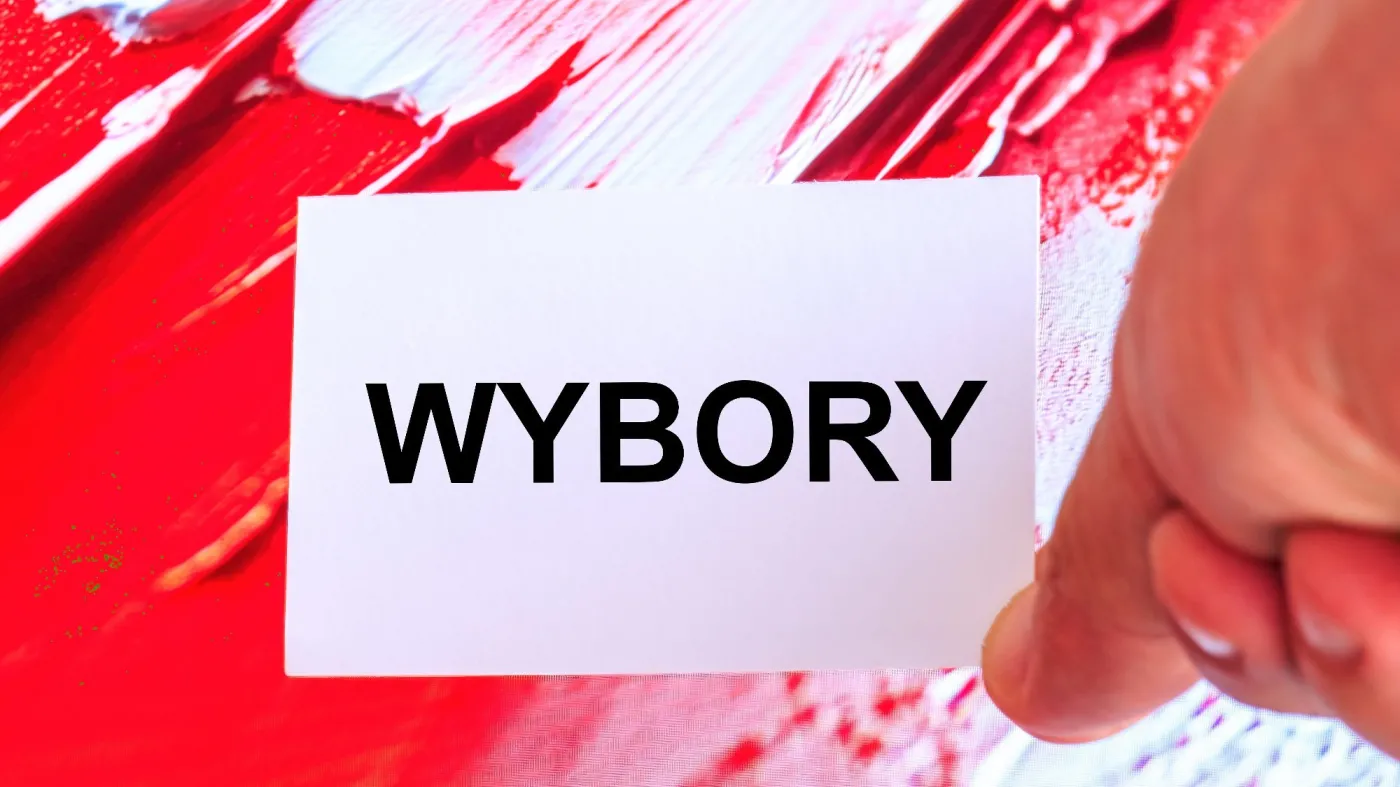 A,Hand,Holding,A,White,Card,With,Word,Wybory,English: