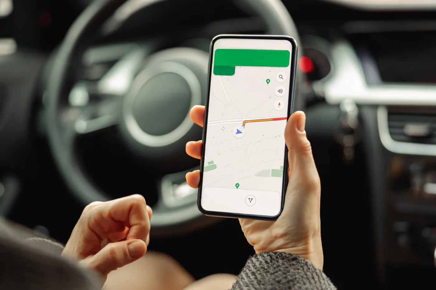 Closeup,Of,Female,Driver,Using,Cell,Phone,With,Gps,Navigation