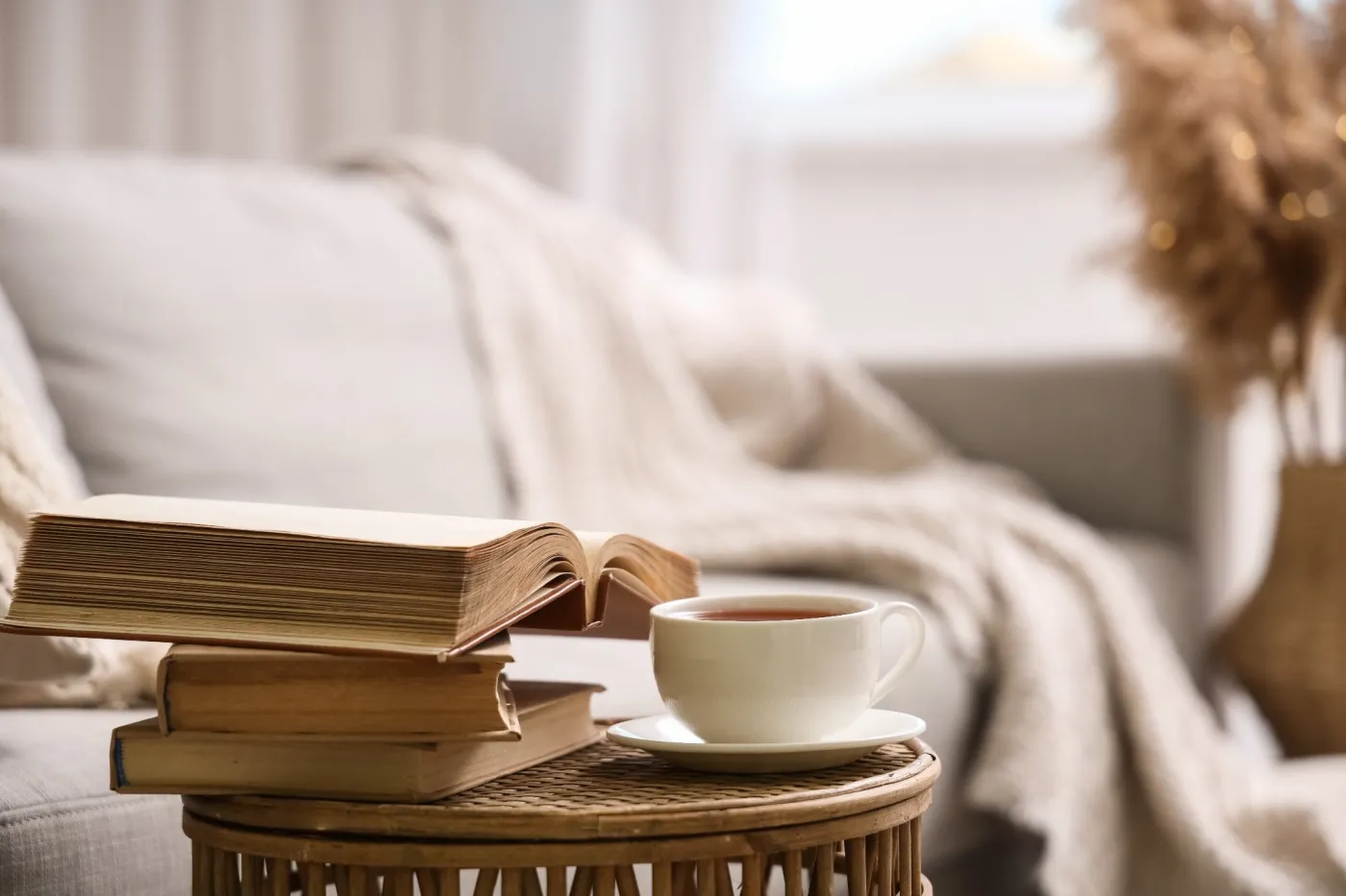 Stack,Of,Books,And,Cup,Of,Coffee,On,Table,In