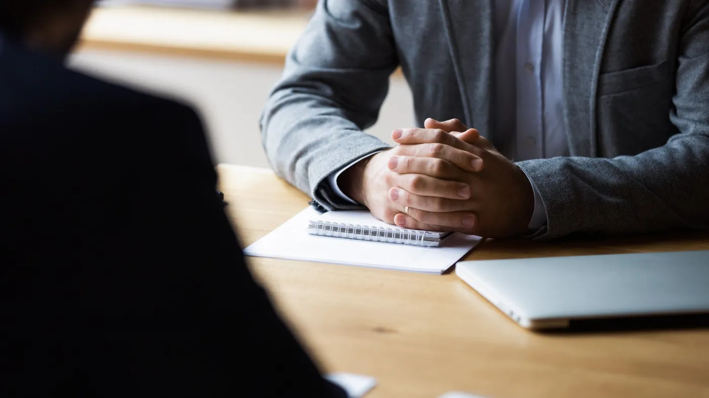 Close,Up,Focus,On,Clasped,Hands,Of,Serious,Male,Entrepreneur