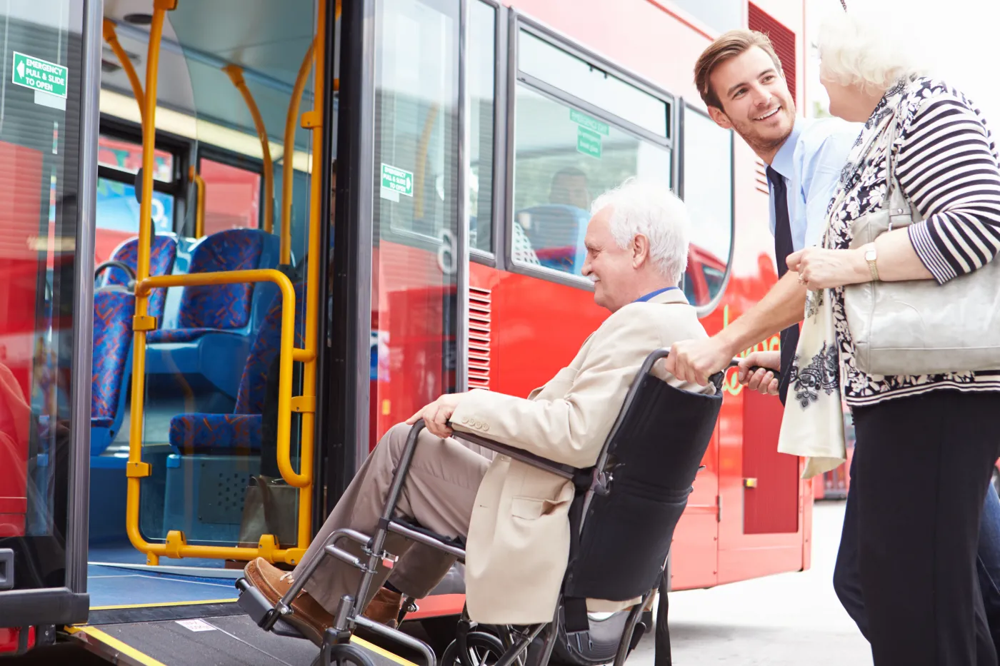Driver,Helping,Senior,Couple,Board,Bus,Via,Wheelchair,Ramp
