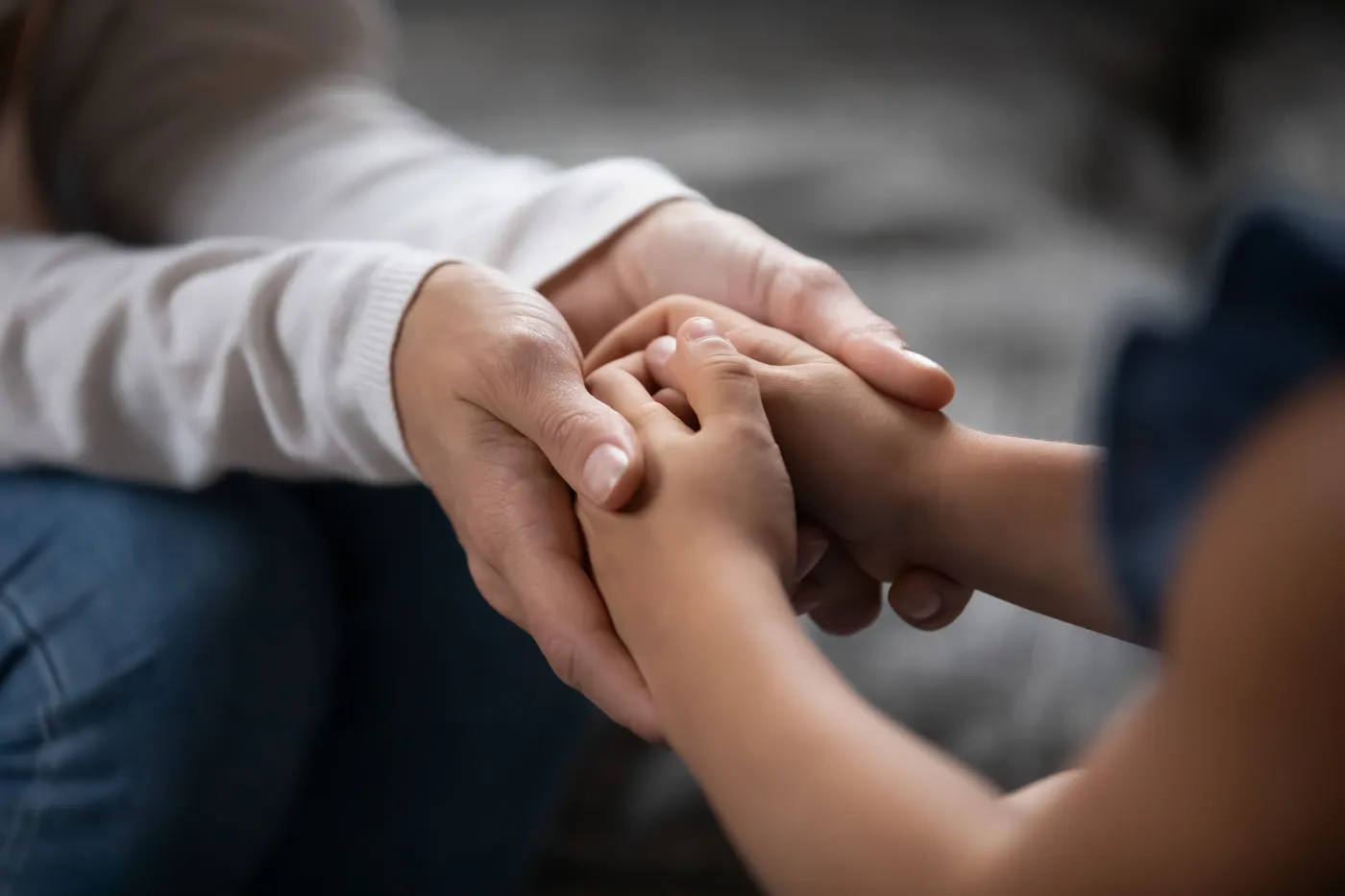 Close,Up,Compassionate,Young,Foster,Parent,Holding,Hands,Of,Little