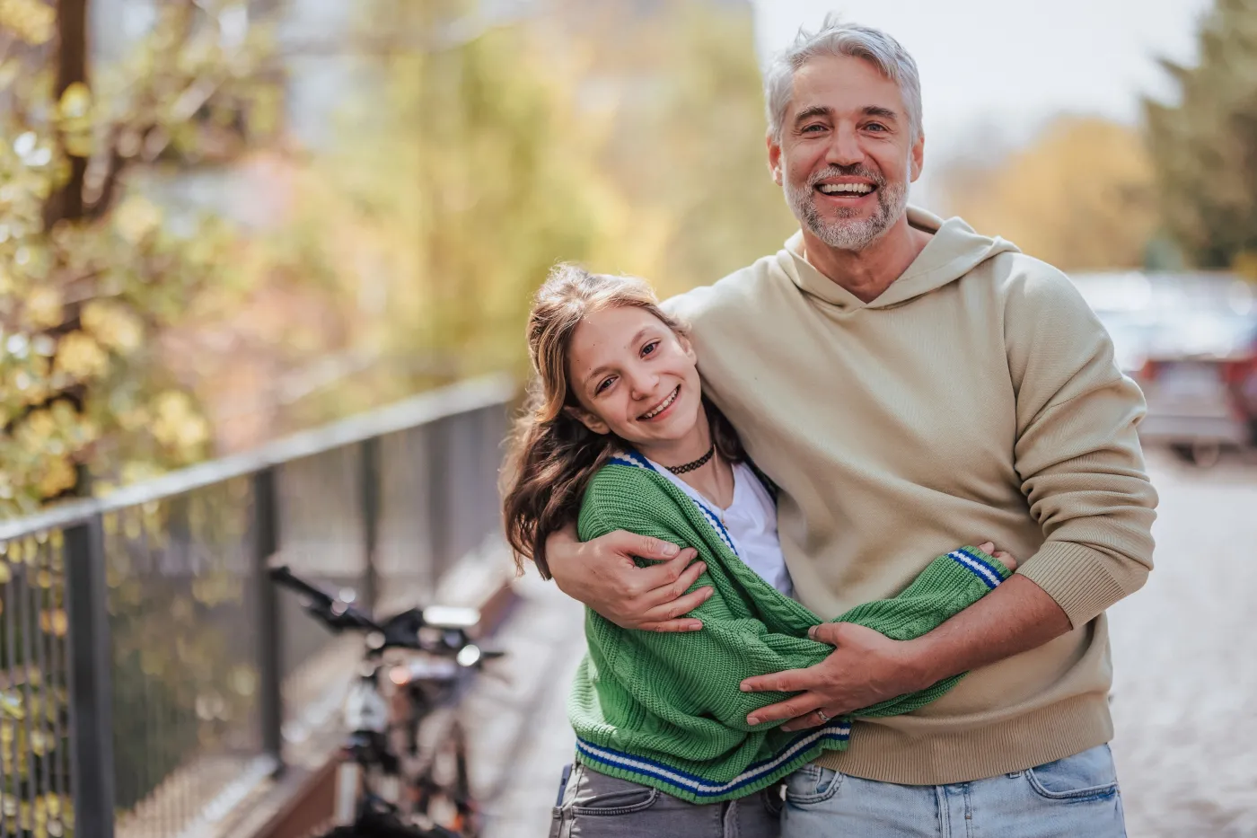 Teenage,Daughter,Hugging,Her,Father,Outside,In,Town,When,Spenidng