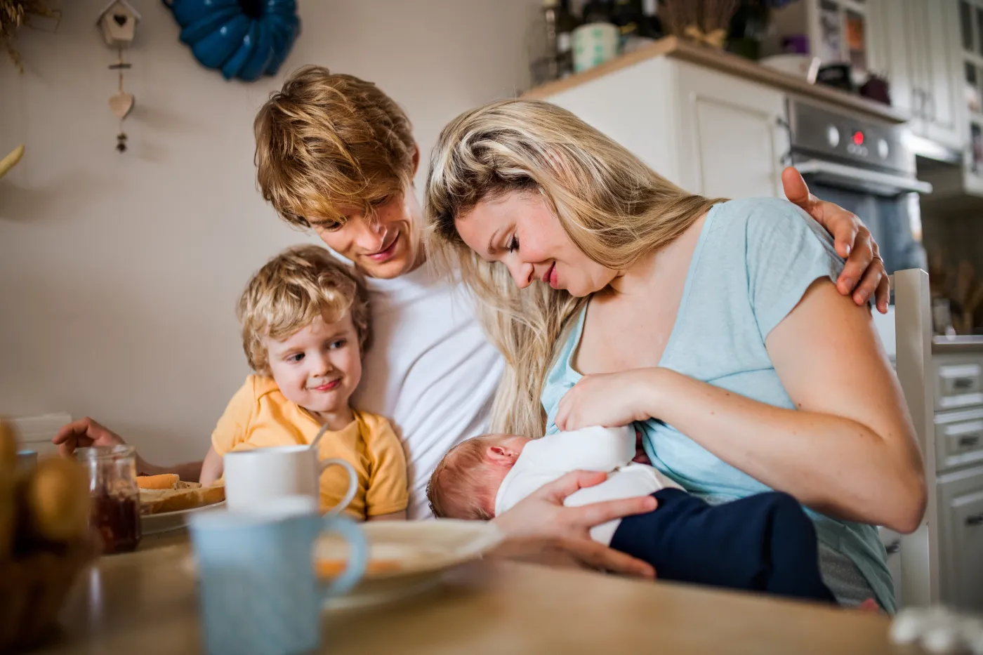 Young,Parents,With,Newborn,Baby,And,Small,Toddler,Son,At