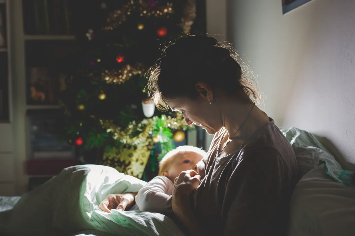 Young,Beautiful,Mother,,Breastfeeding,Her,Newborn,Baby,Boy,At,Night,