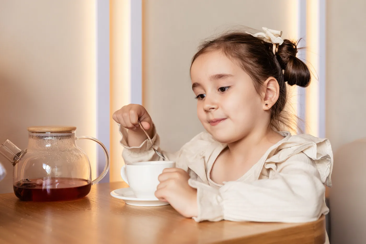 Cute,Little,Brunette,Girl,Drinking,A,Hot,Tea,With,Spoon