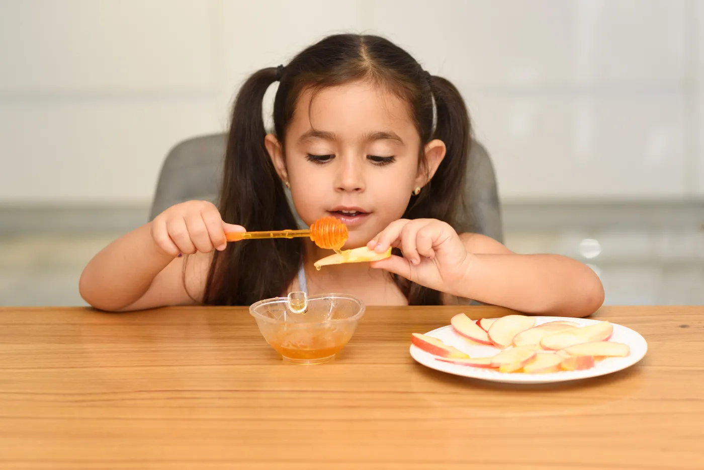 Little,Girl,Eating,Apple,With,Honey.,Healthy,Eating,For,Children.
