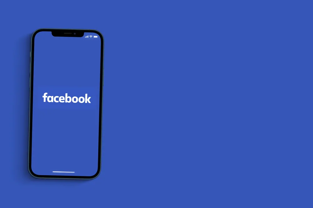 Facebook,App,On,Smartphone,Screen,On,Blue,Background.,Social,Media