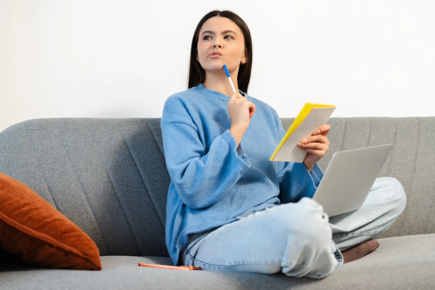 Pensive,Serious,Teen,Girl,Taking,Notes,Using,Laptop,Sitting,On