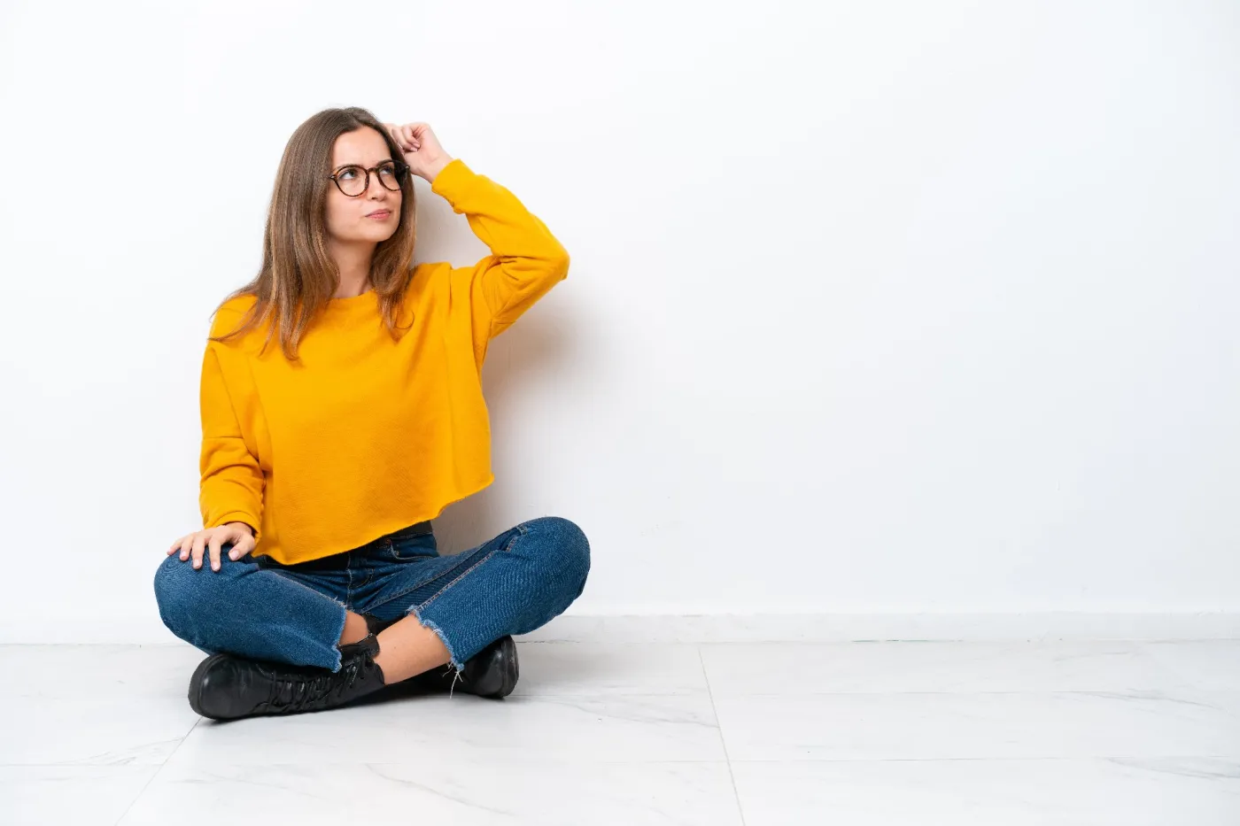 Young,Caucasian,Woman,Sitting,On,The,Floor,Isolated,On,White