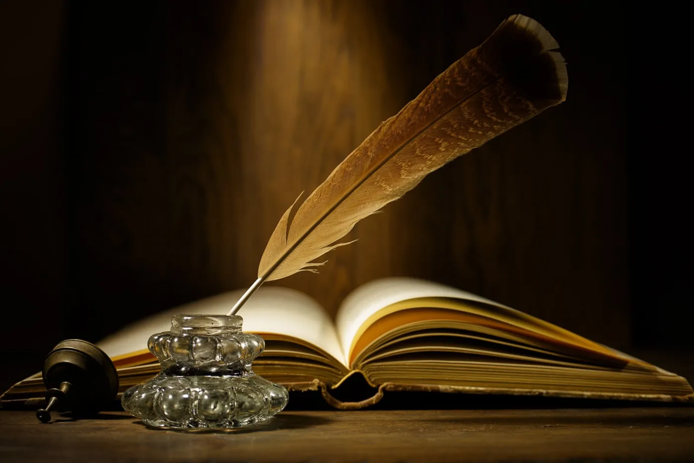 Open,Antique,Book,With,Feather,And,Ink,Bottle,On,Old