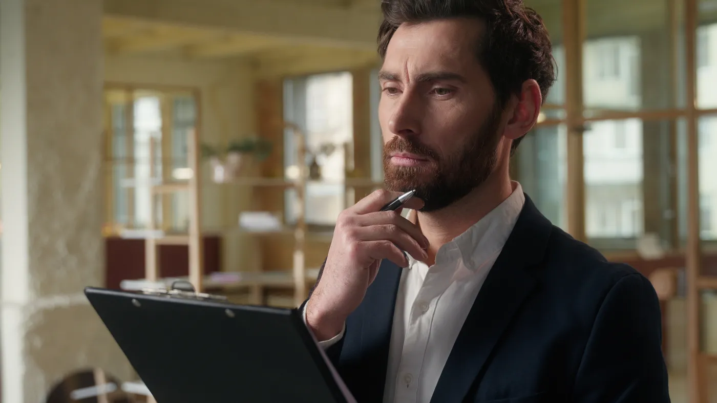 Thoughtful,Business,Man,Writing,Papers,Documents,In,Office,Pensive,Male