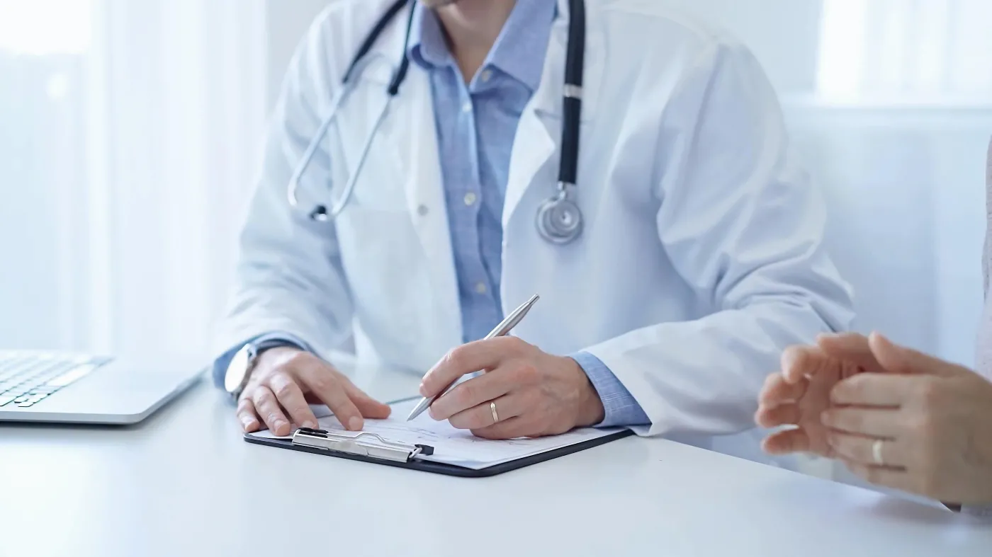 A,Doctor,And,A,Patient.,The,Physician,,Wearing,A,White