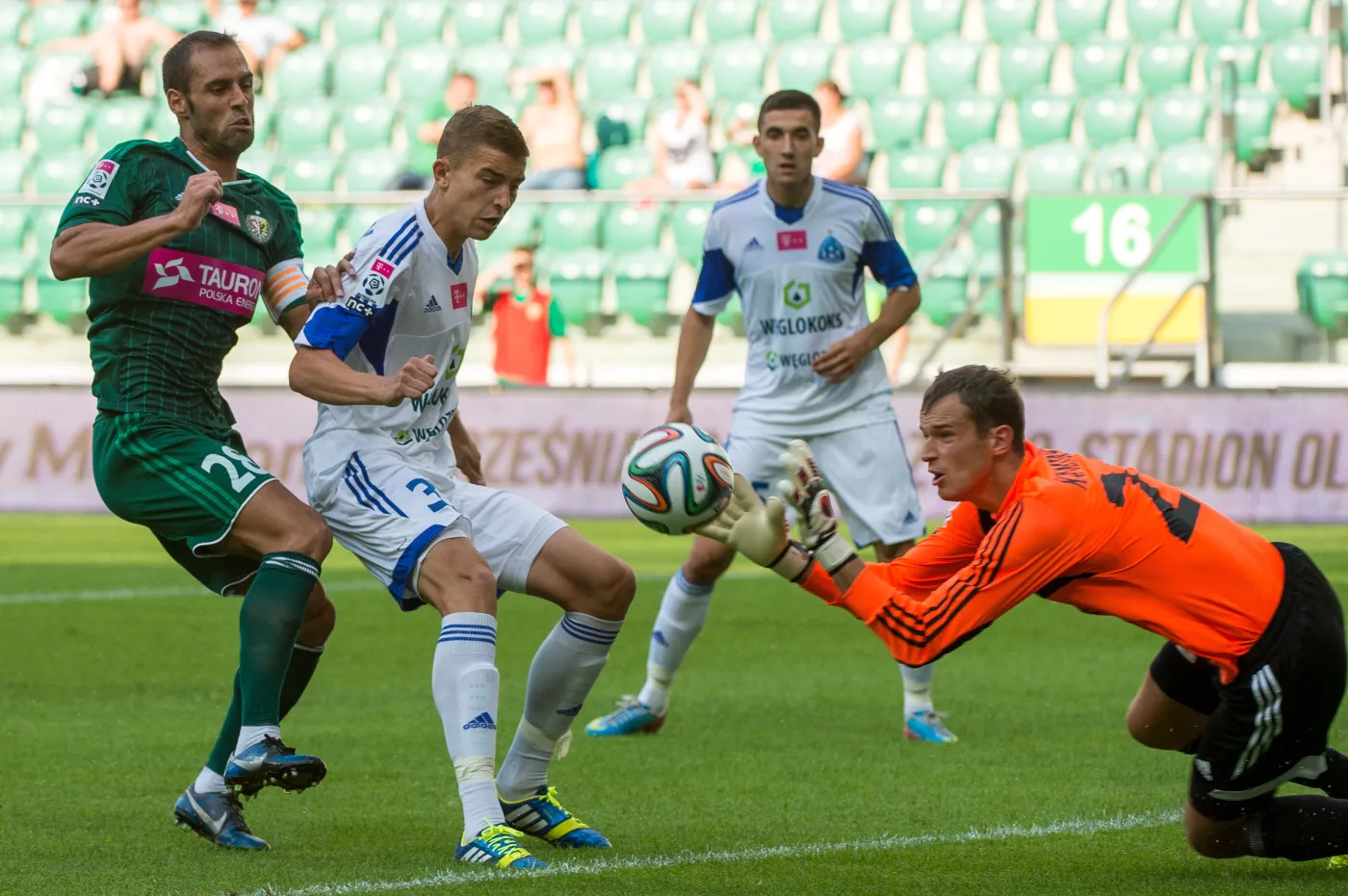 Zawodnik Śląska Wrocław Flavio Paixao (L) oraz Michał Helik (2L) i bramkarz Krzysztof Kamiński (P) z Ruchu Chorzów