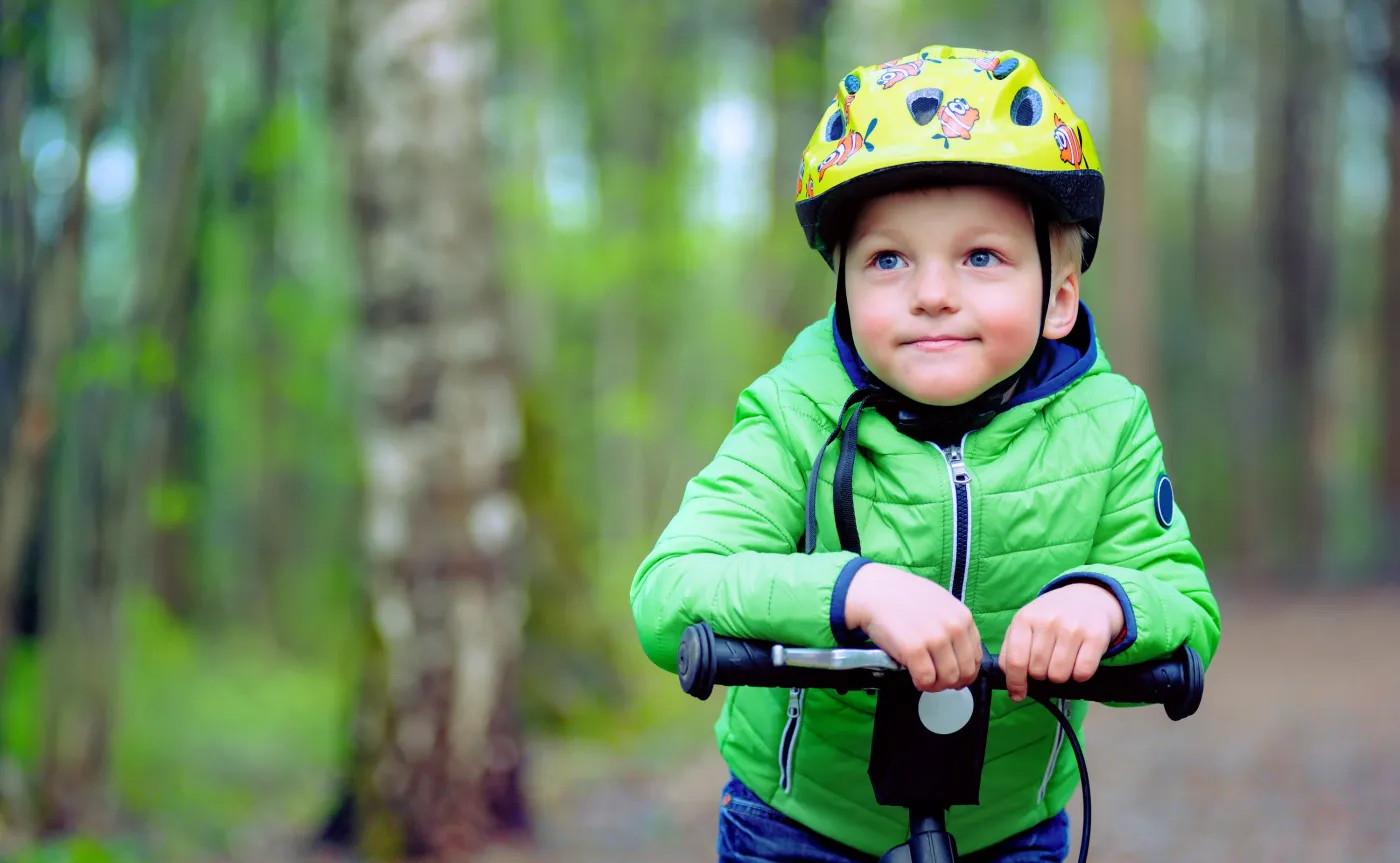 Dziecko na rowerze w kasku na głowie