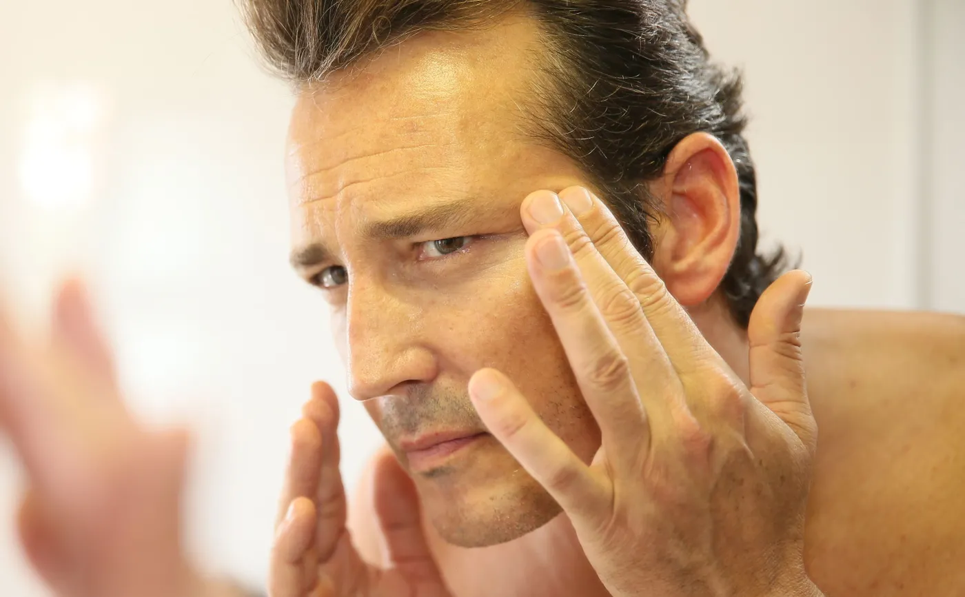 Mężczyzna ogląda swoją skórę