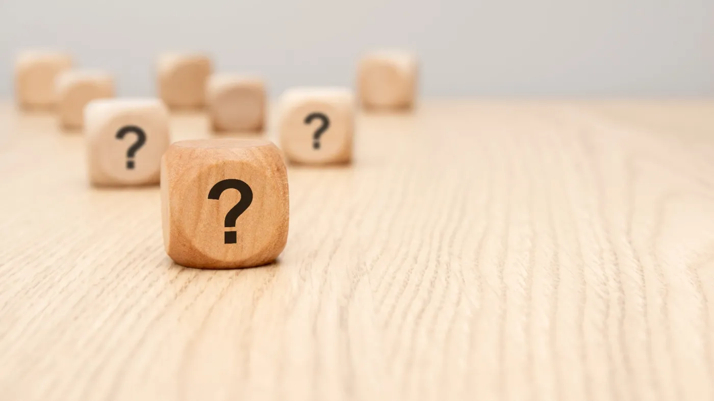 A,Natural,Wooden,Block,Printed,With,Question,Mark,Sits,Sharply