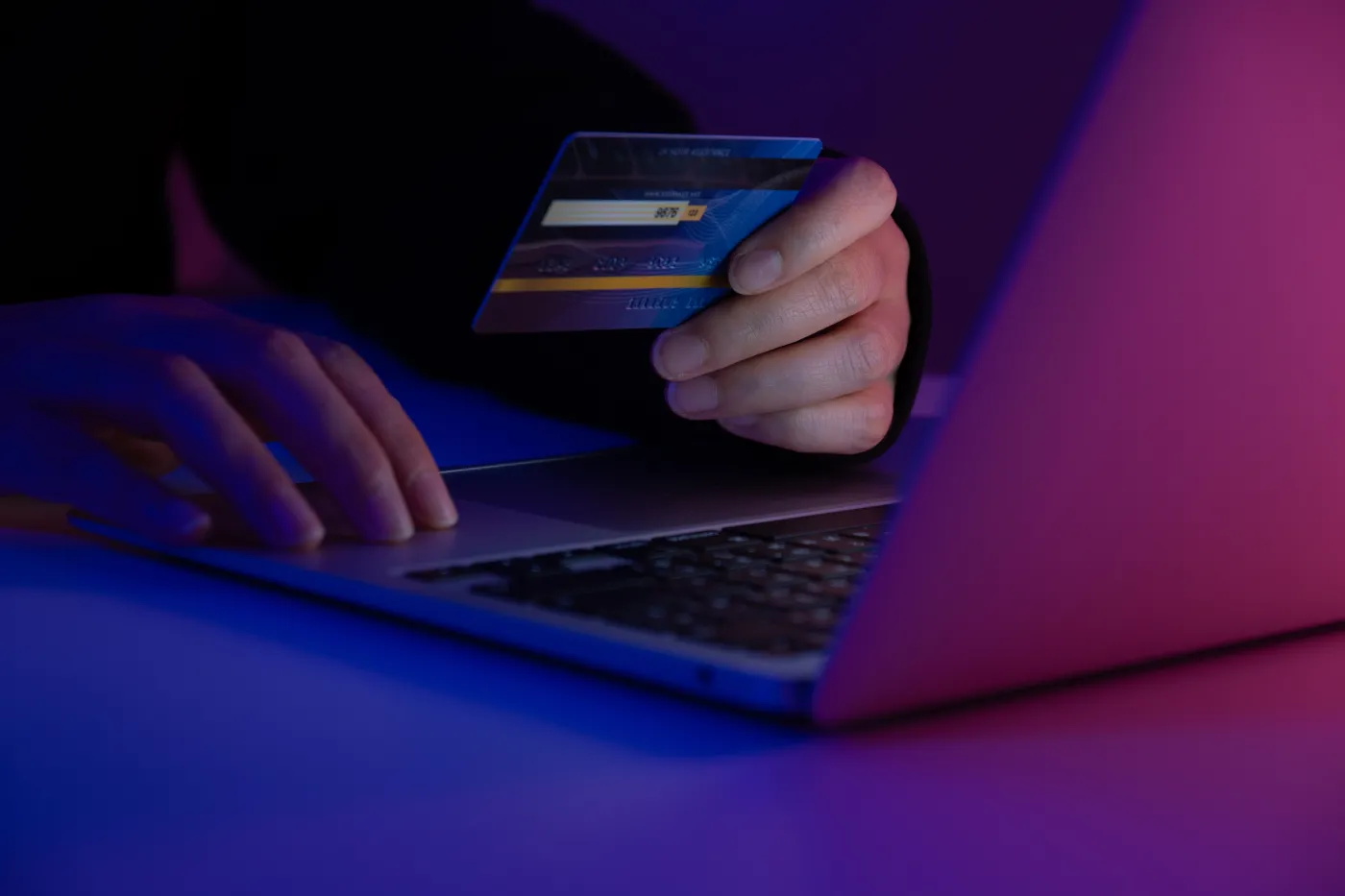 Hacker,Holding,A,Credit,Card,While,Accessing,A,System,With