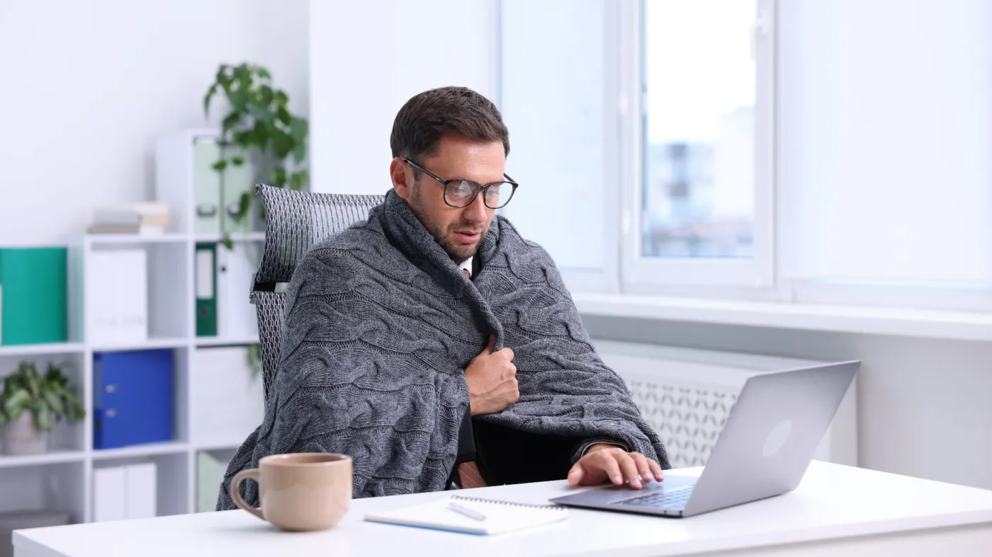 Air,Conditioning.,Man,With,Blanket,Suffering,From,Cold,Temperature,At