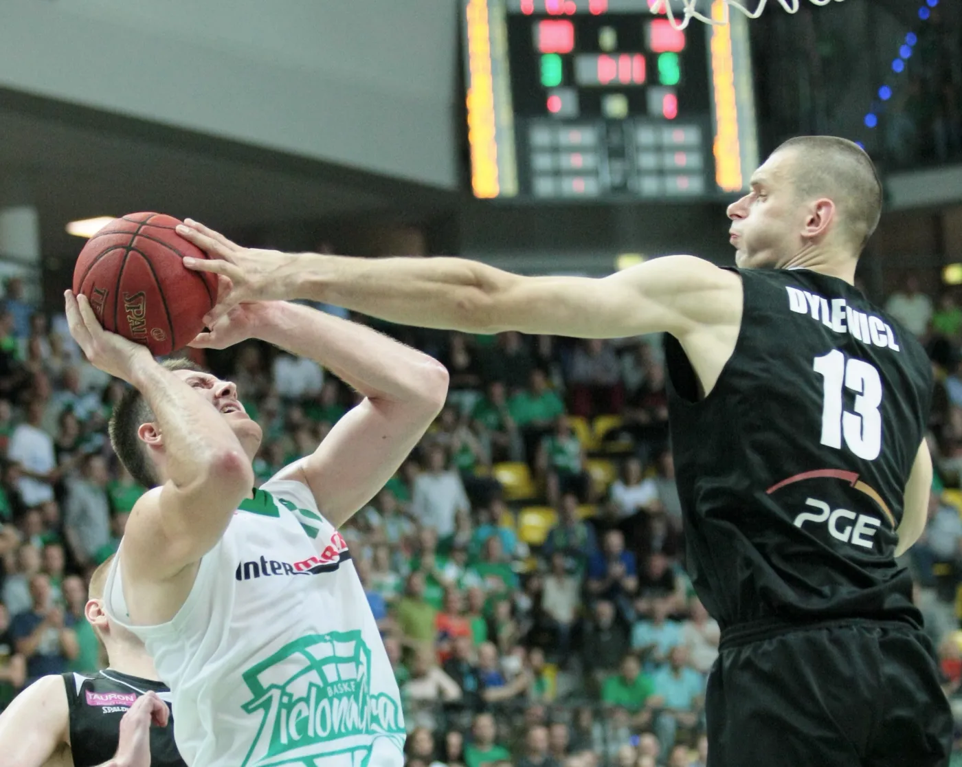 Będący przy piłce Vladimir Dragicevic (L) z miejscowego Stelmetu blokowany przez Filipa Dylewicza (P) z PGE Turów Zgorzelec w trzecim finałowym meczu play off ekstraklasy koszykarzy, rozegranym w Zielonej Górze