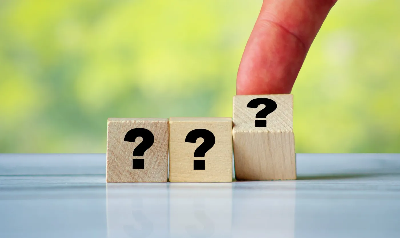 Question,Mark,On,Wooden,Block,With,Human,Hand,Or,Finger.