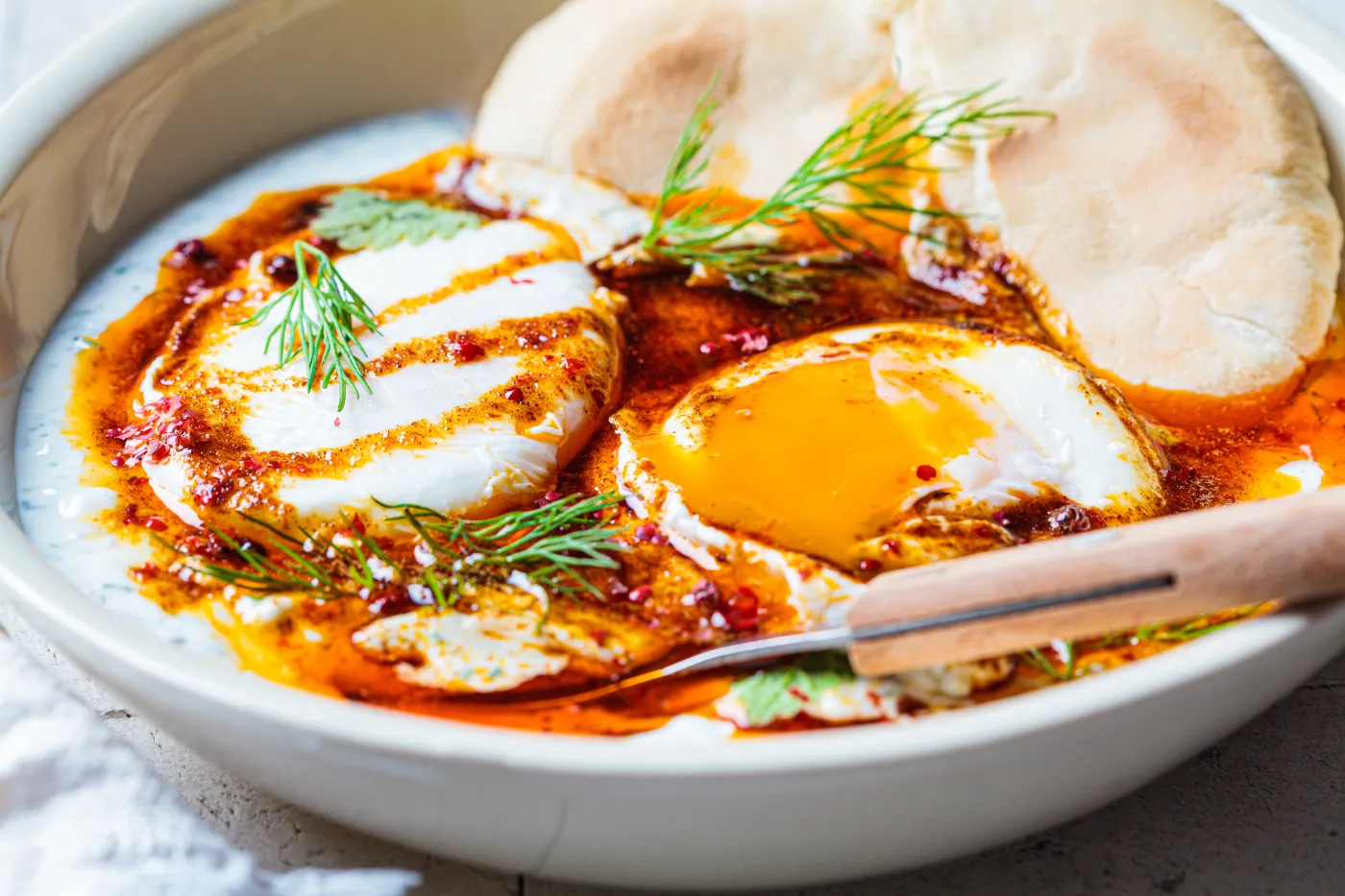 Turkish,Eggs,Cilbir,In,A,White,Bowl.,Turkish,Cuisine,Concept.