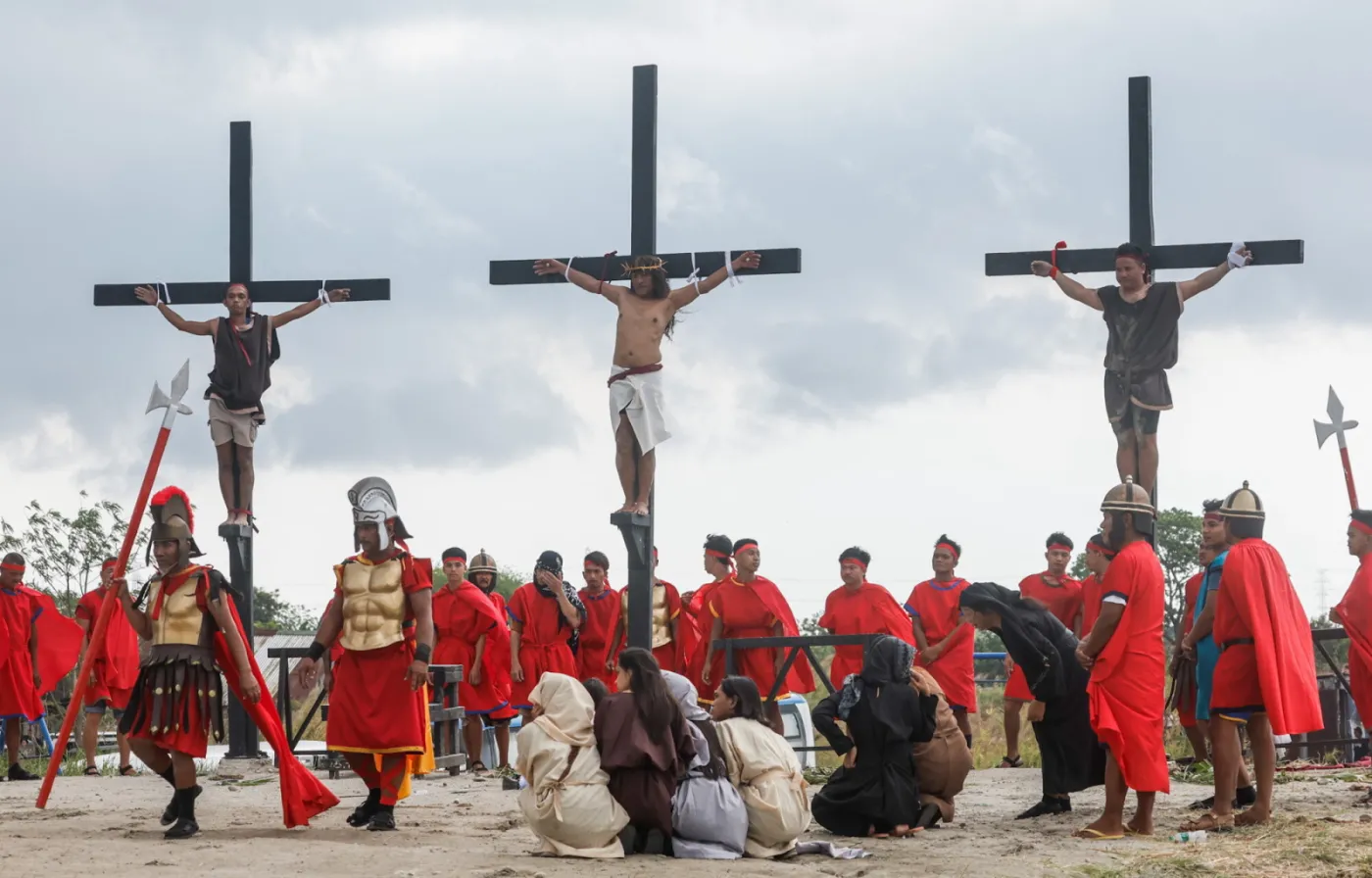 Catholic penitent nailed to cross on Good Friday in Holy Week of Lent