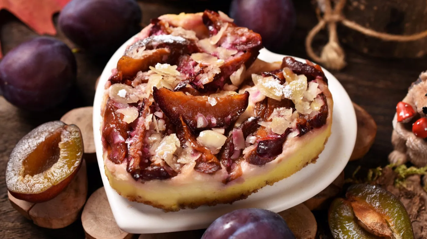 Homemade,Plum,Cheesecake,In,Heart,Shape,With,Almond,Flakes,On