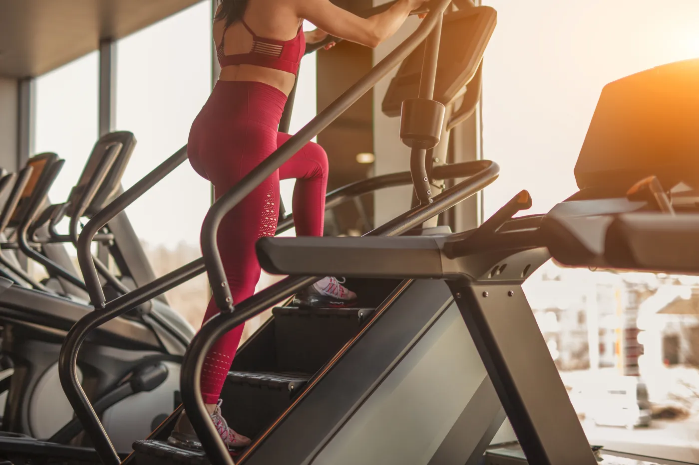 Crop,Side,View,Of,Adult,Sportive,Woman,Exercising,On,Stepper