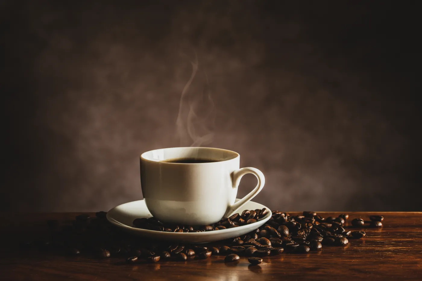 Hot,Coffee,And,Coffee,Beans,On,The,Table