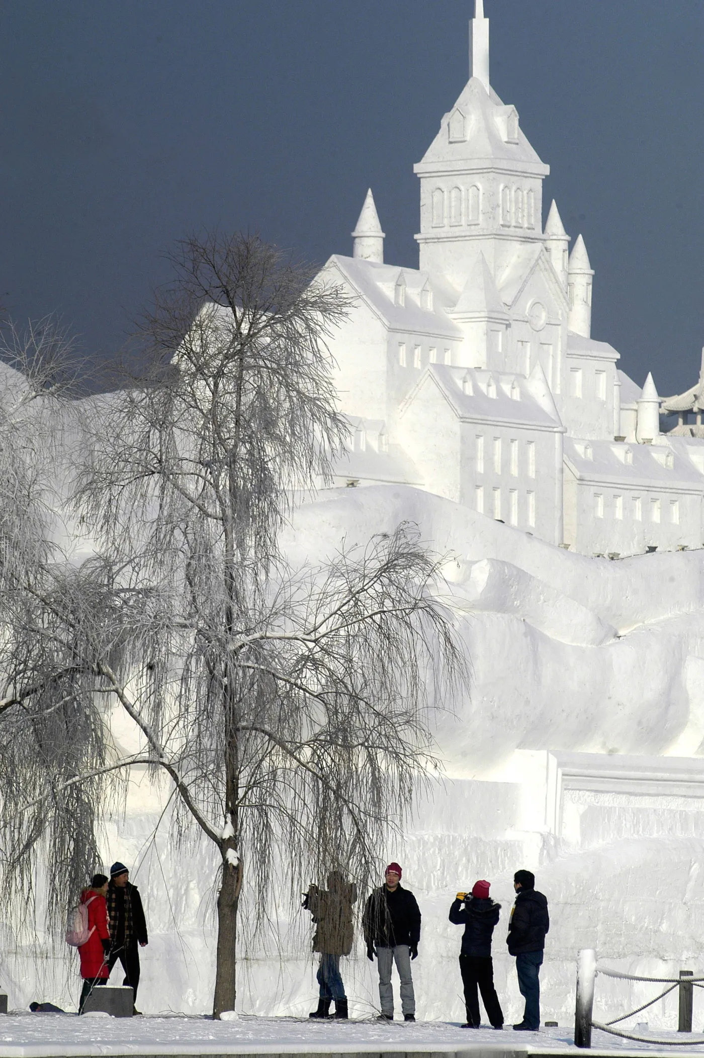 Visitors admire the giant snow sculptures at the 20th Harbin International Ice-Snow Sculpture Expo, in Harbin, northeastern China apos;s Heilongjiang province 20 December 2007. China, a rising tourism powerhouse that in 2006 drew 49.6 million foreign visitors, could unseat France as the number one holiday venue well before 2020.    CHINA OUT GETTY OUT        AFP PHOTO