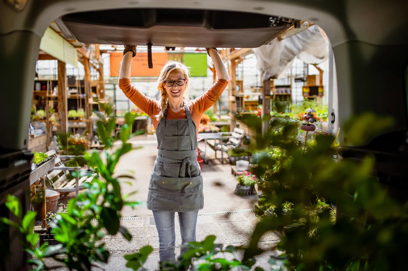 Garden Center Worker Transporting Plants