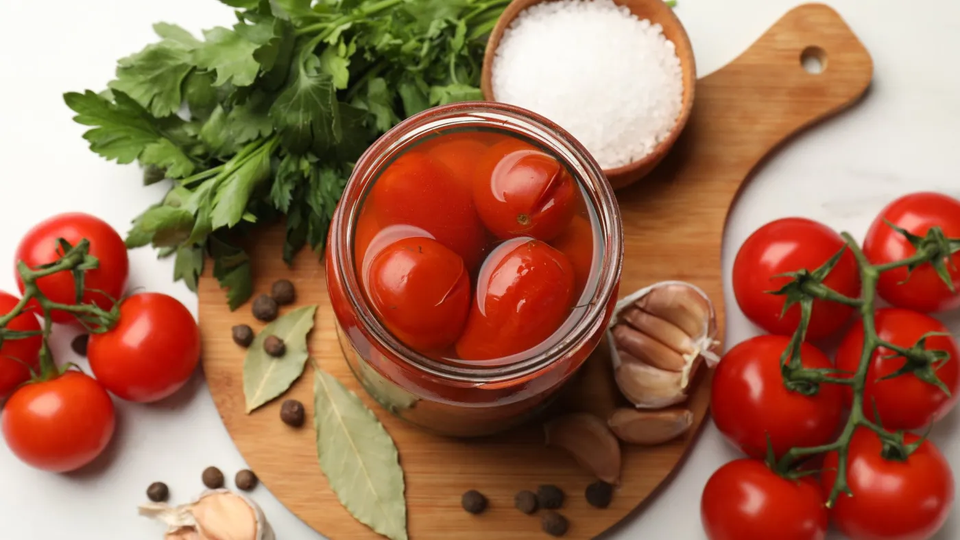 Tasty,Pickled,Tomatoes,In,Jar,And,Ingredients,On,White,Marble