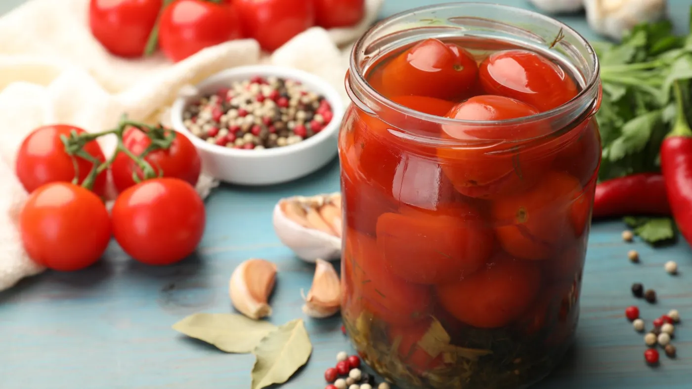 Tasty,Pickled,Tomatoes,In,Jar,And,Ingredients,On,Light,Blue